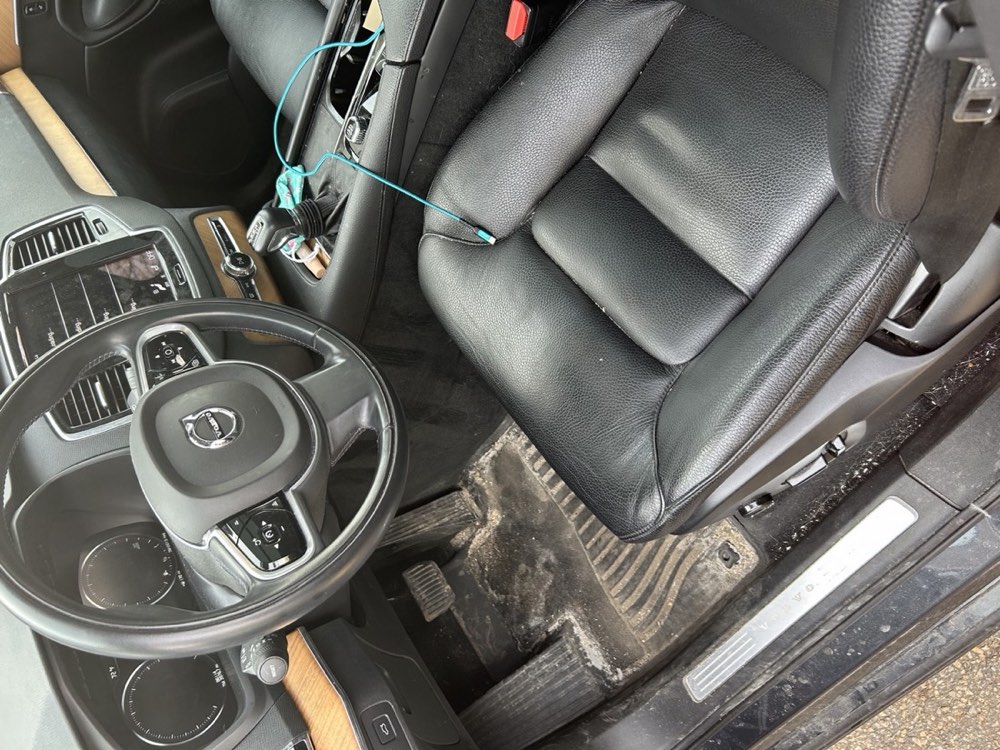 Car interior before detailing — heavily soiled carpet